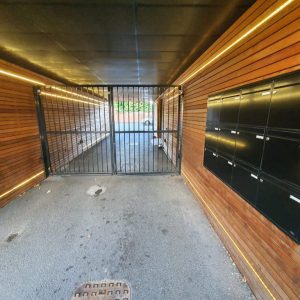 Communal metal access gate at the end of an entrance passage