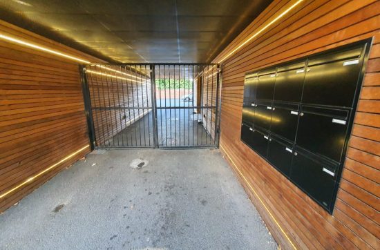 Communal metal access gate at the end of an entrance passage