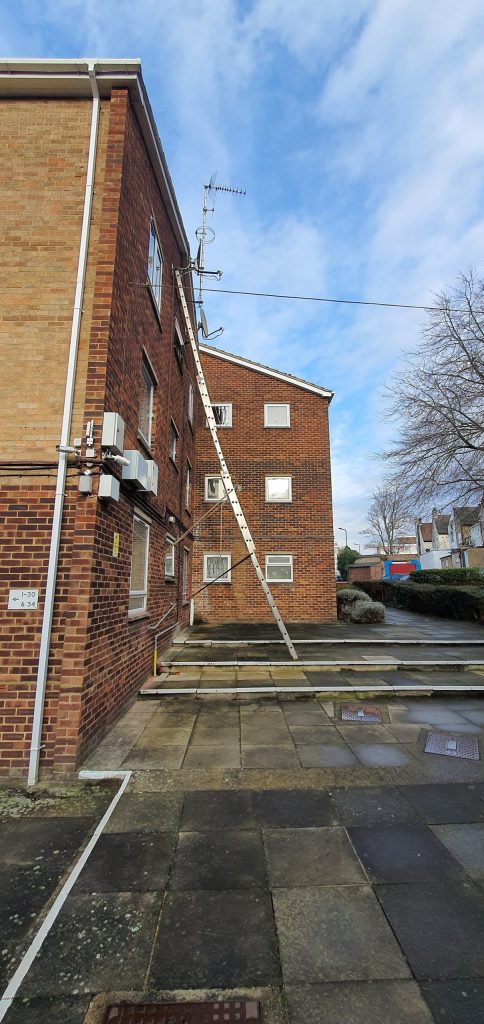 Satellite dishes mounted on the exterior wall of a residential building